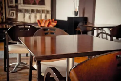 a wooden table and chairs in a room at Del Fundador in Cordoba