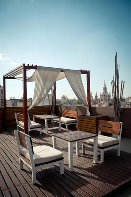 a deck with chairs and a gazebo on a roof at Del Fundador in Cordoba