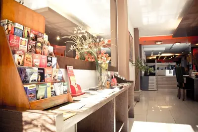 a restaurant with a long counter with books at Del Fundador in Cordoba