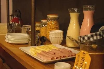 a plate of hot dogs and cheese on a table at Casa Urbana Hotel in Cordoba
