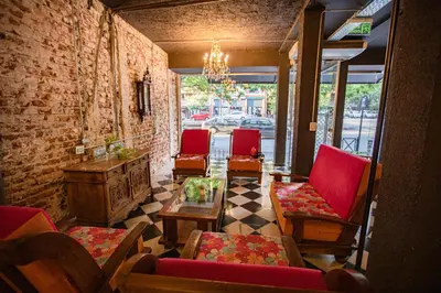 a room with chairs and a table and a fireplace at Casa Urbana Hotel in Cordoba