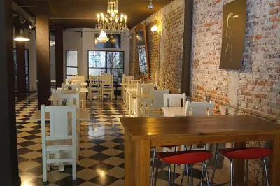 a restaurant with white chairs and a table in a room at Casa Urbana Hotel in Cordoba