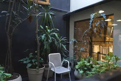 a patio with a chair and some plants at Casa Urbana Hotel in Cordoba