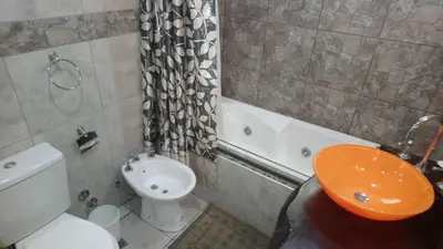 a bathroom with a sink and a toilet and a tub at Merlo 1 in Merlo