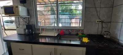 a kitchen with a sink and a stove and a window at Merlo 1 in Merlo