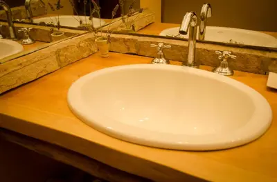 a white sink in a bathroom with two sinks at Cabañas Agalma in Villa Yacanto
