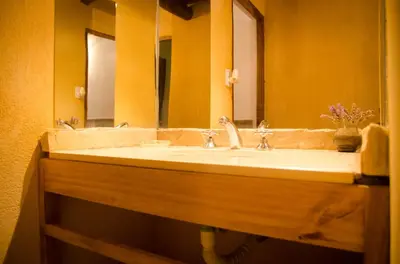 a bathroom with a sink and a mirror at Cabañas Agalma in Villa Yacanto