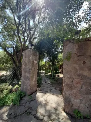 a stone wall with a light on top of it at Complejo de Cabañas Estancia Del Águila in Mina Clavero