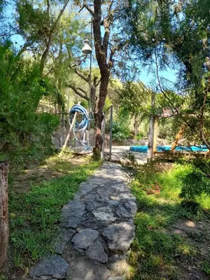 a playground in a park with a water slide at Complejo de Cabañas Estancia Del Águila in Mina Clavero