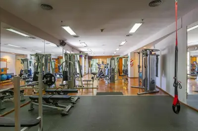 a gym with a lot of equipment in a room at Quinto Centenario Hotel in Cordoba
