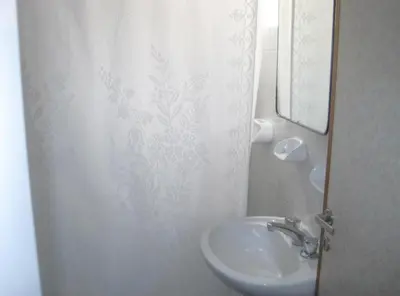 a bathroom with a sink and a shower curtain at Apart Hotel Magali in Cordoba