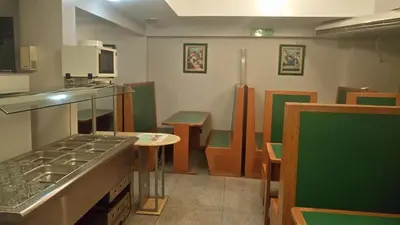 a kitchen with a sink and a stove top oven at Apart Hotel Magali in Cordoba