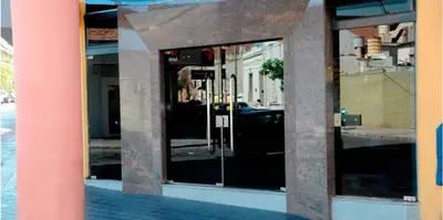 a window of a building with a reflection of a street at Apart Hotel Magali in Cordoba