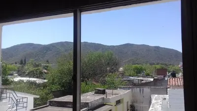 a view of a mountain from a window at Residencial Ariand in Santa Rosa de Calamuchita