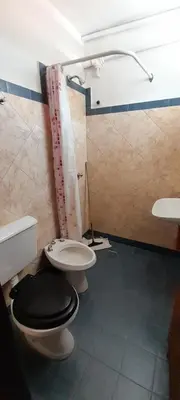 a bathroom with a toilet and a sink at Residencial Ariand in Santa Rosa de Calamuchita