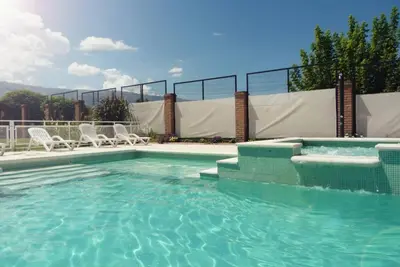 a swimming pool with chairs and a swimming pool at Complejo Abuela Lety in Merlo
