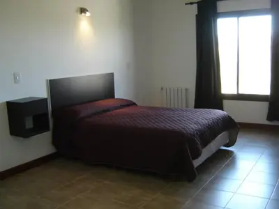a bedroom with a bed in a room with a window at Complejo Abuela Lety in Merlo