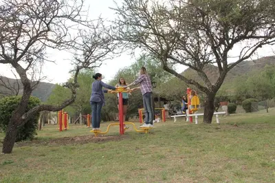 a group of people playing on a playground at Posada Jardin del Cerro in Santa Rosa de Calamuchita