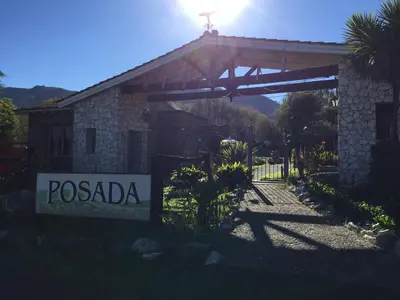 a house with a sign in front of it at Posada Jardin del Cerro in Santa Rosa de Calamuchita