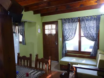 a living room with a couch and a window at Cabañas de los Comechingones in Merlo