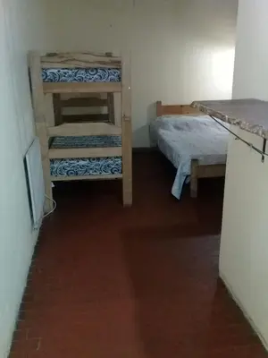 a room with two bunk beds and a table at La Neofita in Mina Clavero
