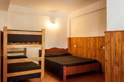 a bedroom with two bunk beds in a room at La Neofita in Mina Clavero