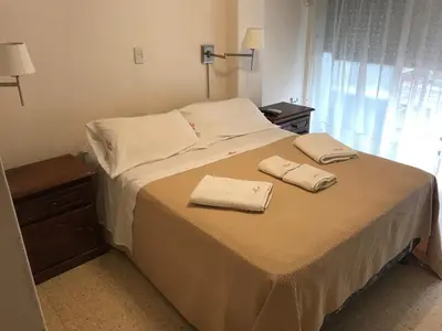 a bedroom with a bed with two towels on it at Cordoba Inn Apart Hotel in Cordoba