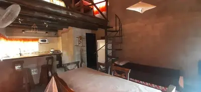 a room with a table and a ladder in a kitchen at Cabaña Silvana in Bialet Massé