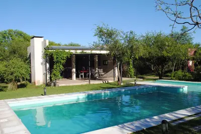 a swimming pool in front of a house at Casas del Champaquí in San Javier