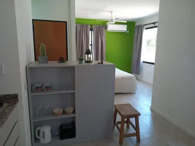 a room with a bedroom with a bed and a table at Casas del Champaquí in San Javier