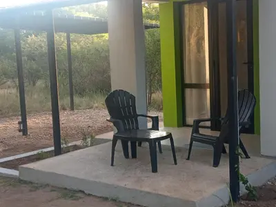 two chairs and a table on a porch at Casas del Champaquí in San Javier