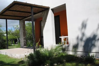 a house with an open door in a yard at Casas del Champaquí in San Javier