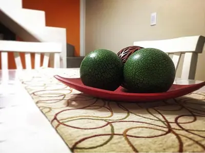 two avocados on a plate on a table at Altos del Tala Deptos - Cabañas in Embalse