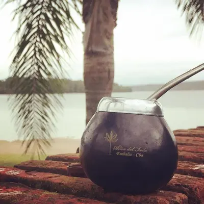 a glass bowl with a spoon sitting on a wall at Altos del Tala Deptos - Cabañas in Embalse