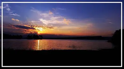 a sunset over a large body of water at Altos del Tala Deptos - Cabañas in Embalse