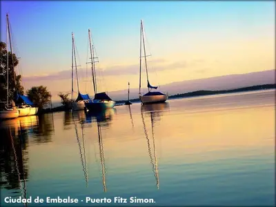 a group of boats sitting in the water at Altos del Tala Deptos - Cabañas in Embalse