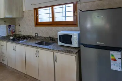 a kitchen with a stainless steel refrigerator and a microwave at Portal de la Virgen in Villa General Belgrano