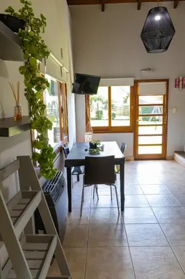 a living room with a table and a dining room at Portal de la Virgen in Villa General Belgrano