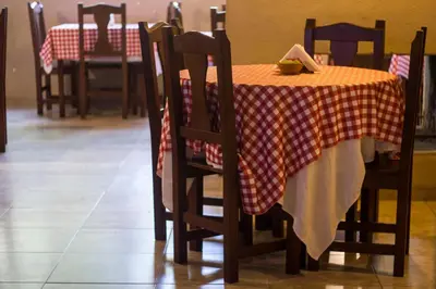 a table with a red and white checkered table cloth at Solares Cumbrecita Hotel & Apart in La Cumbrecita