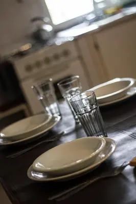 a table with plates and glasses on top of it at Solares Cumbrecita Hotel & Apart in La Cumbrecita