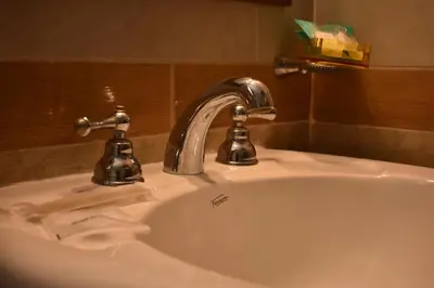a sink with a faucet in a bathroom at Solares Cumbrecita Hotel & Apart in La Cumbrecita