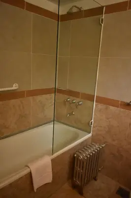 a bathroom with a bath tub and a shower at Solares Cumbrecita Hotel & Apart in La Cumbrecita