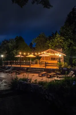 a park with benches and lights at night at Solares Cumbrecita Hotel & Apart in La Cumbrecita