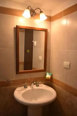 a bathroom with a sink and a mirror at Solares Cumbrecita Hotel & Apart in La Cumbrecita