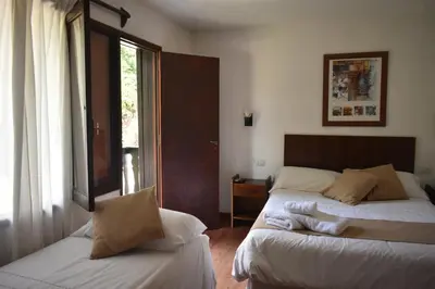 a bedroom with two beds and a window at Solares Cumbrecita Hotel & Apart in La Cumbrecita