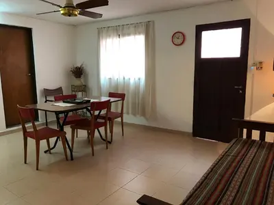 a dining room with a table and chairs and a window at LF Departamentos in Cordoba