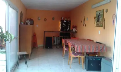 a kitchen with a table and chairs in a room at LF Departamentos in Cordoba