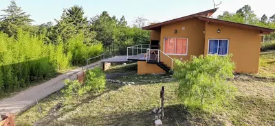 a small house in the middle of a field at Terrazas de Nahuascat in Santa Rosa de Calamuchita