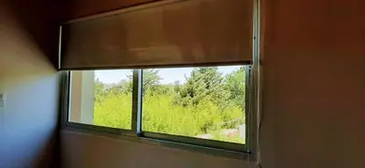 a window with a view of a field of trees at Terrazas de Nahuascat in Santa Rosa de Calamuchita