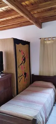 a bedroom with a bed with a painting on the wall at Departamento Con Vistas a La Montaña in Villa Carlos Paz